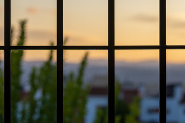 View behind the window bars at home due to the coronavirus pandemic