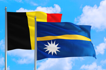 Nauru and Belgium national flag waving in the windy deep blue sky. Diplomacy and international relations concept.