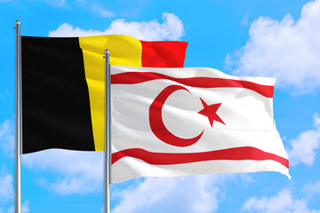 Northern Cyprus and Belgium national flag waving in the windy deep blue sky. Diplomacy and international relations concept.