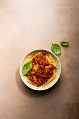 Overhead view of pasta in bowl on stone table