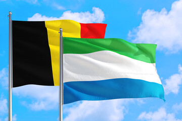 Sierra Leone and Belgium national flag waving in the windy deep blue sky. Diplomacy and international relations concept.