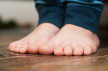 Child's bare feet in pajamas. Fingers and foot.