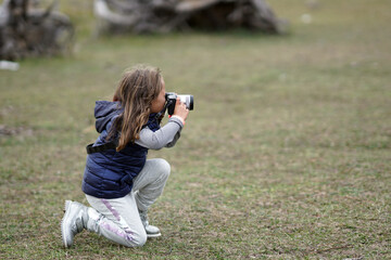 A 5 year old girl takes photographs in the Sila National Park in Italy