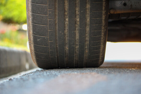 Close up of a wheel parked on the edge of a road