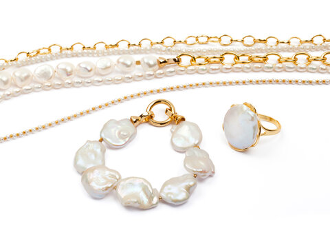 Luxury elegant baroque pearl ring and bracelet with necklaces on white background