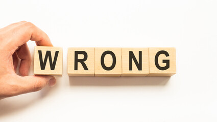 Word wrong. Wooden small cubes with letters isolated on white background with copy space available.Business Concept image.