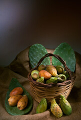 Prickly pears on a piece of jute with a wicker basket

