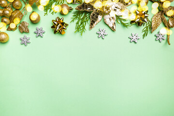 Christmas holidays composition with gold decorations on green background with copy space for your text