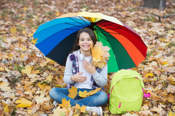 happy teenage girl enjoy autumn forest with beautiful seasonal nature under colorful umbrella hold...