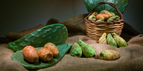 Prickly pears on a piece of jute with a wicker basket
