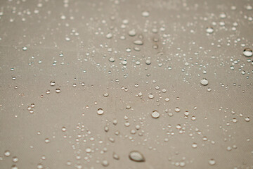 Beige / brown / gray umbrella fabric with small rain drops on it