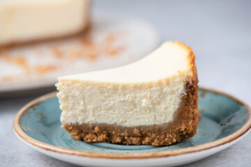 Slice Of Classical New York Cheesecake On A Blue Plate, Closeup View, Selective Focus