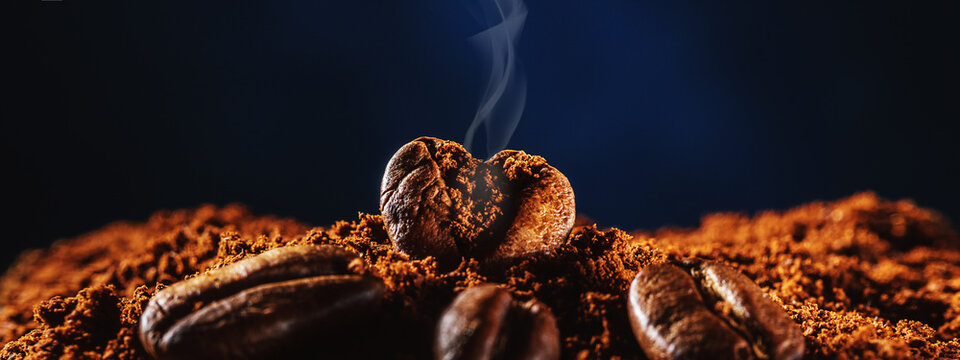 Coffee bean in the form of heart with aromatic smoke from copies of space.
