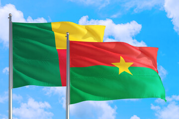 Burkina Faso and Benin national flag waving in the windy deep blue sky. Diplomacy and international relations concept.