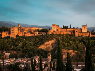The Alhambra in Granada during a sunset with beautiful views of the city at its best, articulating...