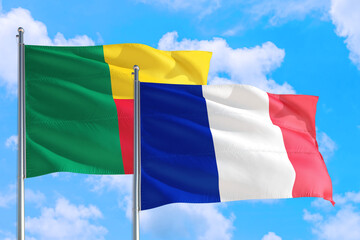 France and Benin national flag waving in the windy deep blue sky. Diplomacy and international relations concept.