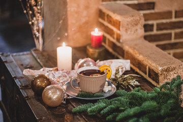 Red hot drink glintwein with spices, cinnamon, anise, fruits, brown sugar on an old wooden table. New Year and Christmas holidays concept. Mulled wine and glintwein.