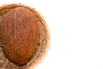 One Coconut In A Wicker Plate In Selective Focus. Isolated Image On A White Background With Copy Space.