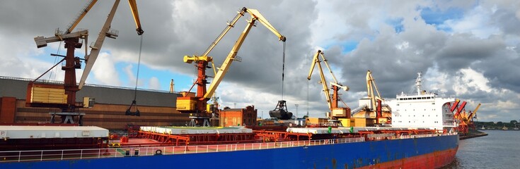 Large blue bulker ship loading coal in the Ventspils free port, Latvia, Baltic sea, Europe. Freight...