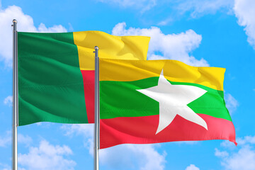 Myanmar and Benin national flag waving in the windy deep blue sky. Diplomacy and international relations concept.