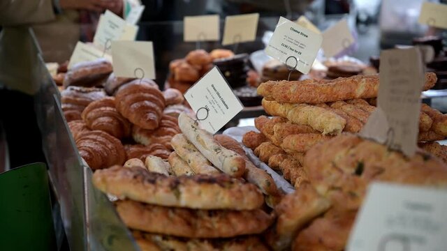 Pastries and breads piled high and ready for sale at a stall in Borough Market, London