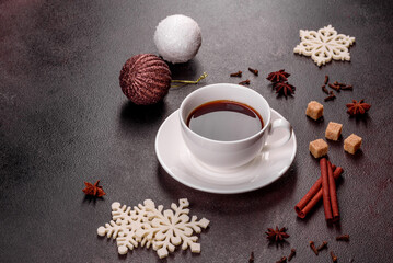 A cup of strong coffee on the Christmas table with spruce twigs and toys