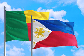 Philippines and Benin national flag waving in the windy deep blue sky. Diplomacy and international relations concept.