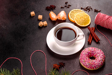 A cup of strong coffee on the Christmas table with spruce twigs and toys