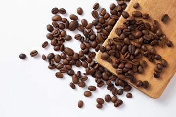 Brown coffee beans on white table close up