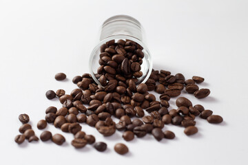 Coffee beans in small glass on white table