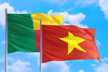 Vietnam and Benin national flag waving in the windy deep blue sky. Diplomacy and international relations concept.