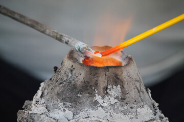 Bead making over a medieval kiln reproduction