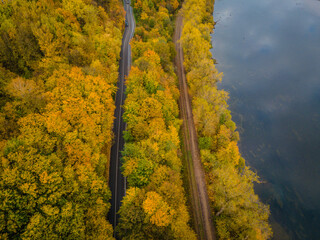 Aerial scenery view of winding road and railway beside in autumn fall