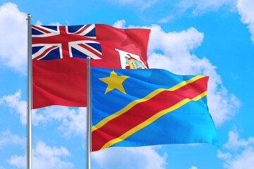 Congo and Bermuda national flag waving in the windy deep blue sky. Diplomacy and international relations concept.