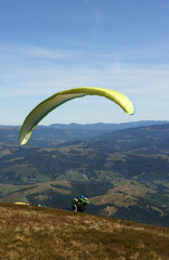 Paraglider preparing to jump from the mountain