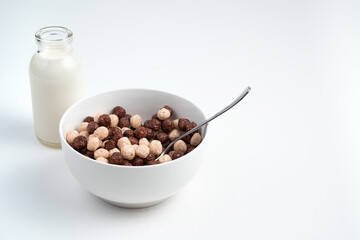 Plate with round wheat and chocolate flakes on a light background. Side view with space for copying. The concept of proper nutrition.
