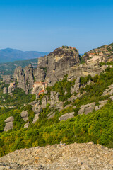 Beautiful vertical view of the monasteries (Varlaam, Rousanou, St. Nicolaus, an Great Meteoron) of Meteora, Thessaly, Greece with spectacular unique rock formations