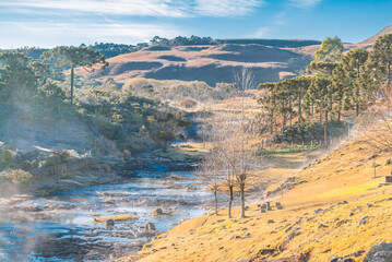 Rural winter landscape with frost at the side river in the fields of the mountain range of Santa...