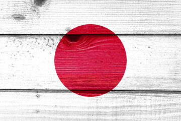 Japan flag painted on old wood plank background. Brushed natural light knotted wooden board texture. Wooden texture background flag of Japan