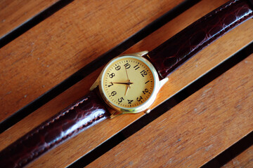 Quartz watch on a wooden background.