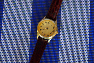 Quartz watch on a white and blue background.