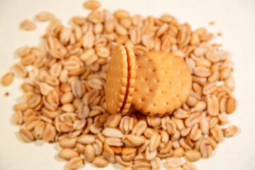 Appetizing brown dry cracker on scattered roasted peanuts