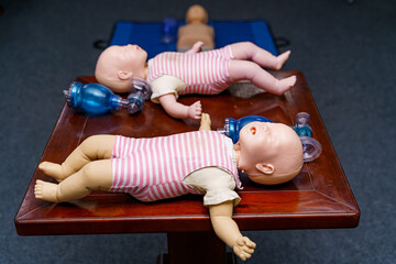 Infant dummy first aid demonstration series. First aid instructor demonstrating artificial...