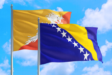 Bosnia Herzegovina and Bhutan national flag waving in the windy deep blue sky. Diplomacy and international relations concept.