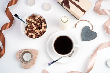 Healthy Breakfast for lovers on a romantic background. Cereal balls, coffee Cup, hearts and ribbons on a light background. The view from the top. Concept of February 14, women's day.