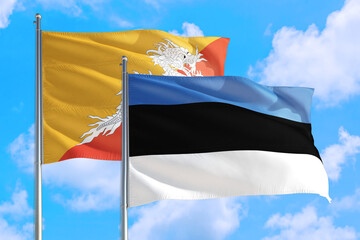 Estonia and Bhutan national flag waving in the windy deep blue sky. Diplomacy and international relations concept.