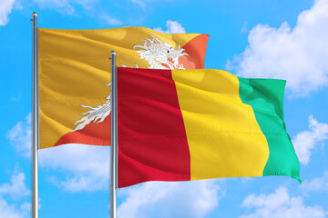 Guinea Bissau and Bhutan national flag waving in the windy deep blue sky. Diplomacy and international relations concept.