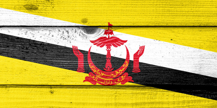 Brunei flag painted on old wood plank background. Brushed natural light knotted wooden board texture. Wooden texture background flag of Brunei