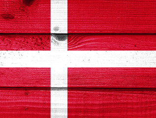 Denmark flag painted on old wood plank background. Brushed natural light knotted wooden board texture. Wooden texture background flag of Denmark