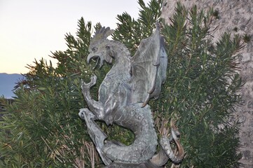 Rijeka, Croatia November 2020. Head of the obelisk statue inside Trsat castle overlooking Rijeka in Croatia. Basilisk statue in Rijeka castle. Bronze sculpture of a mythical Basilisk monster.